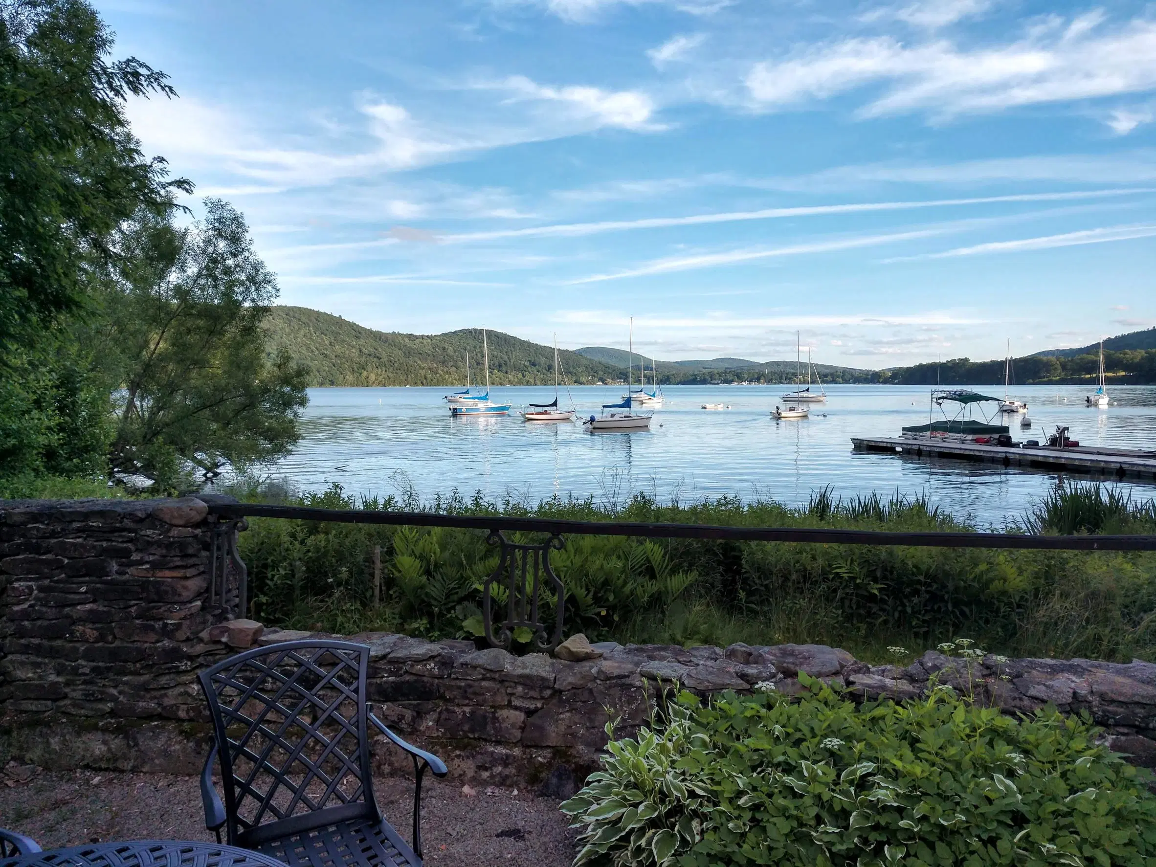 View of Otsego Lake with boats on the water and mountains in the background
