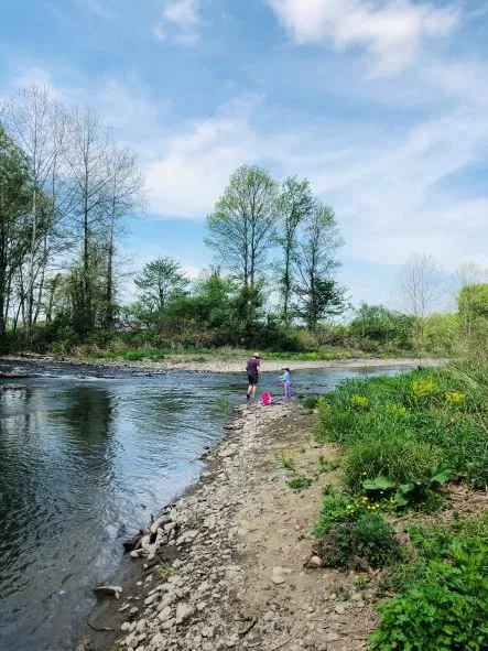 A family exploring near a river