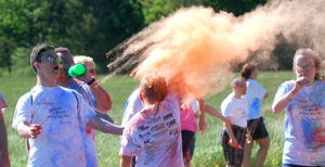 People are showered with color during the fun run