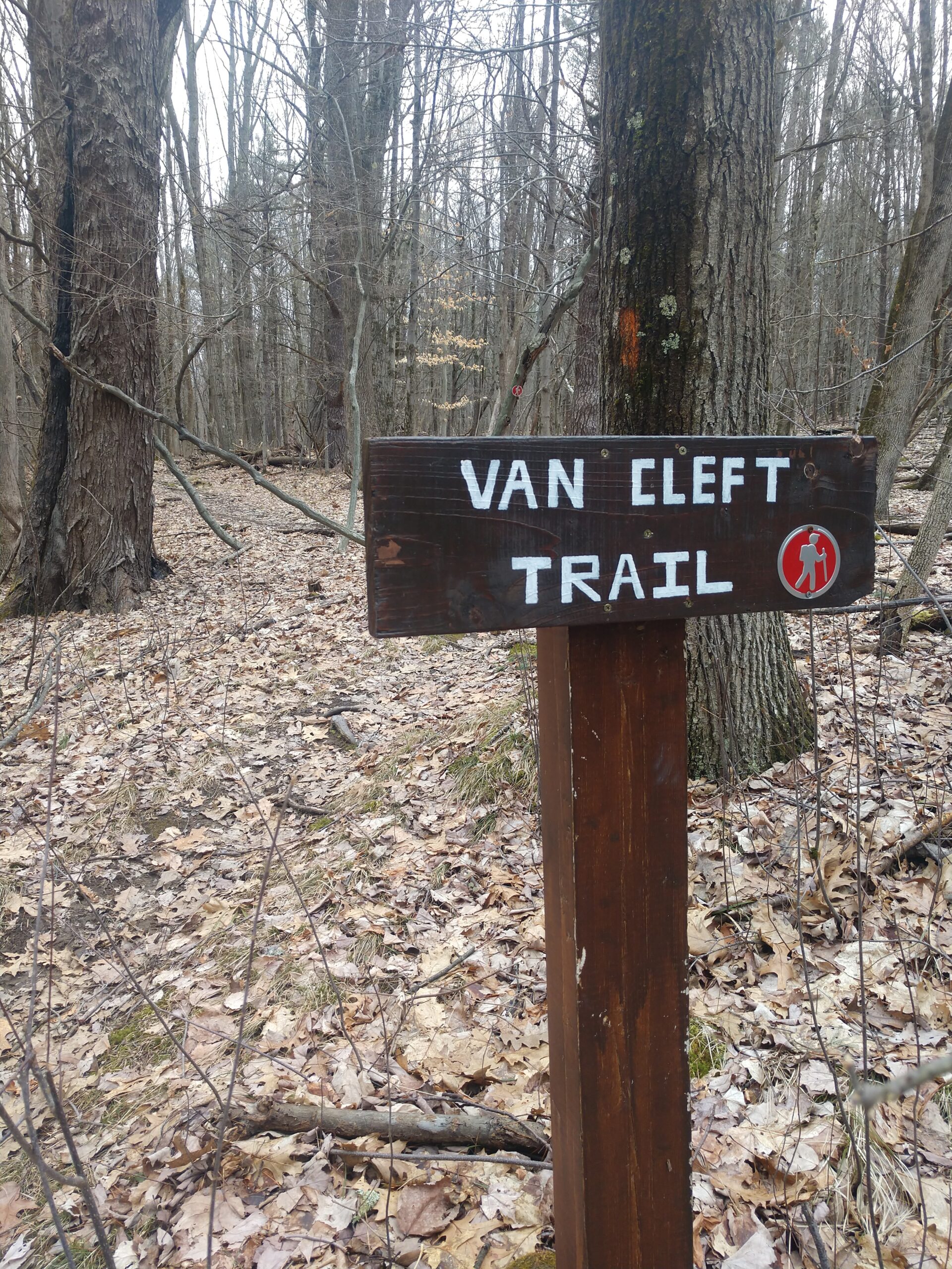 Van Cleft Trail sign along a path in the woods