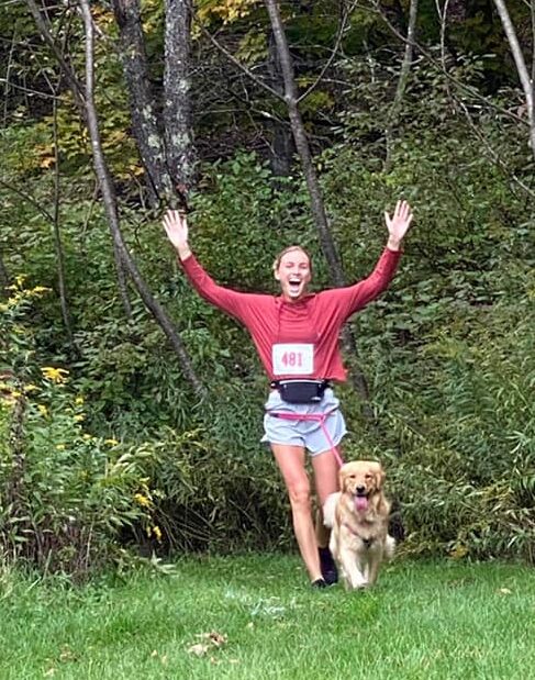 Woman running with her dog in Unatego 5K