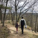 A man and his daughter hiking on the Table Rock trail