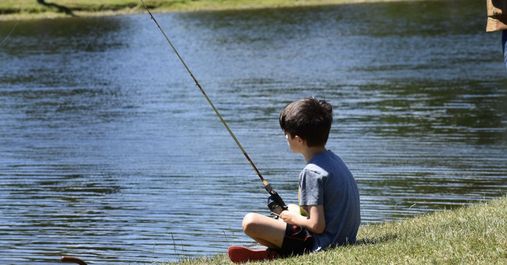 boy fishing by pond