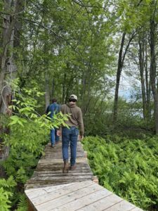 Two people walking along a boardwalk 