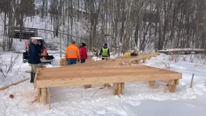 people building a boardwalk in snow